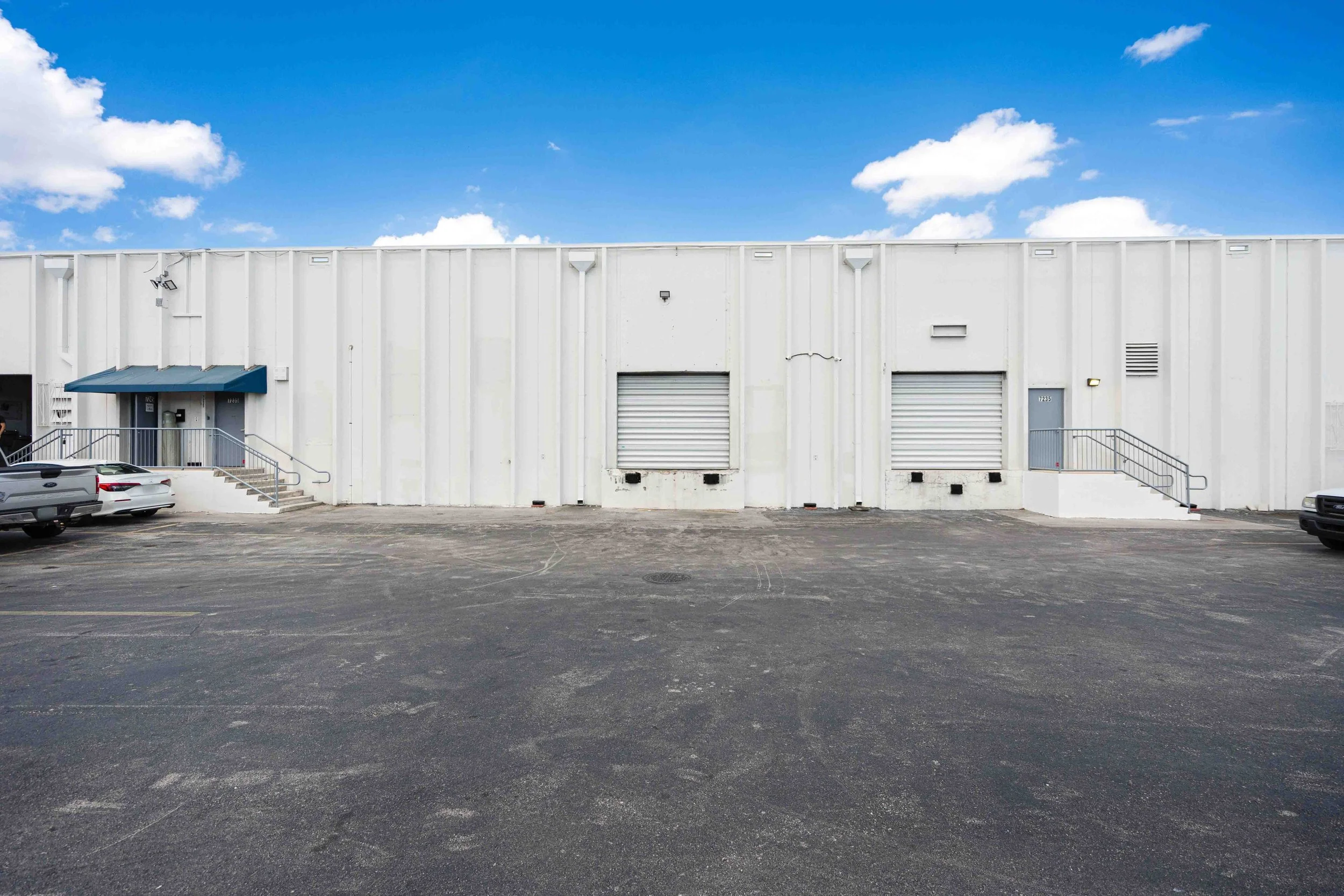 Airport Trade Center warehouse exterior with two loading docks and a paved foreground.