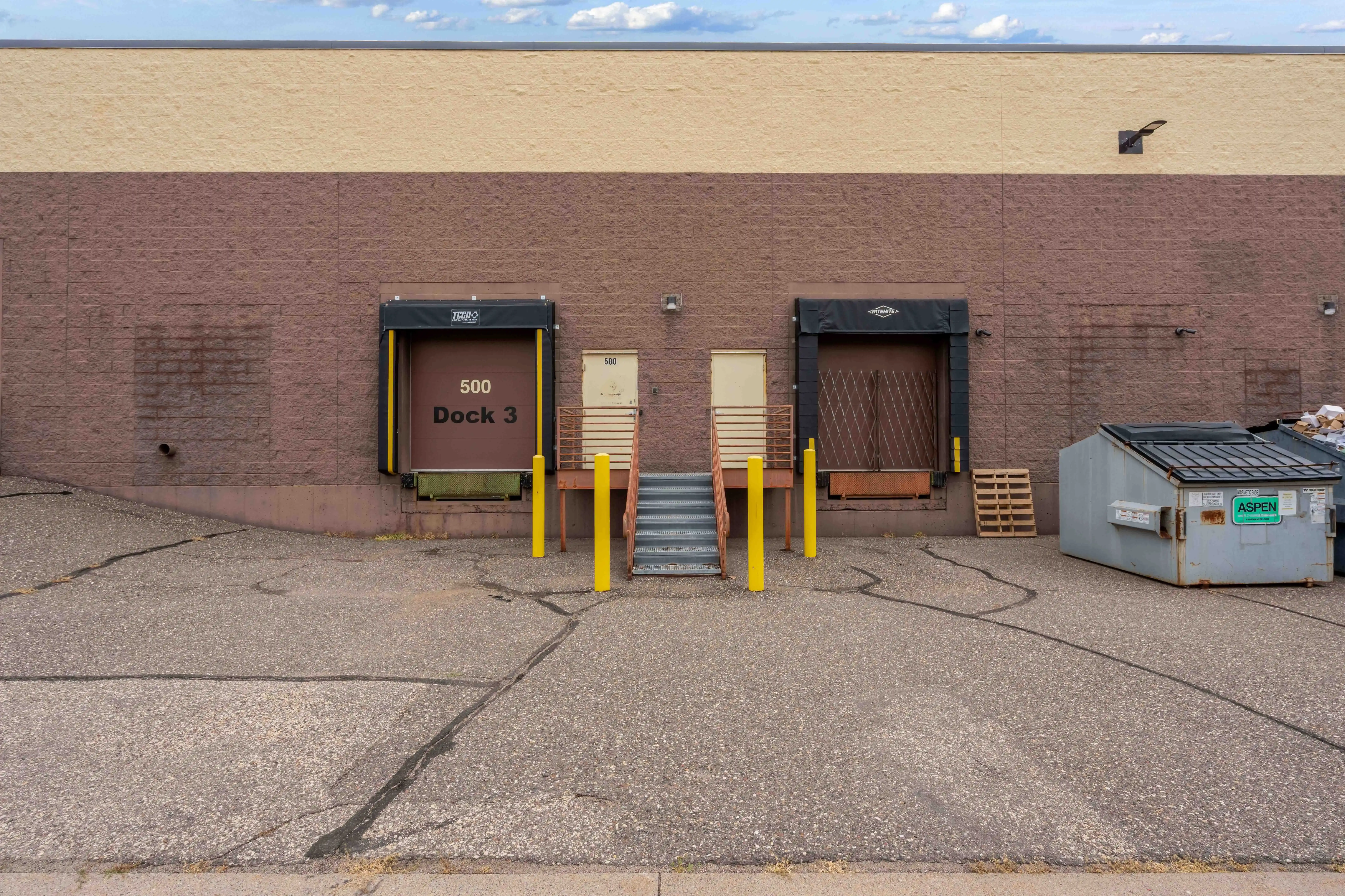 Rice Creek Business Center I loading door and adjacent pedestrian entrance in a brick facade.